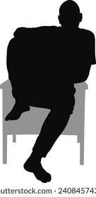 silhouette man sitting on armchair