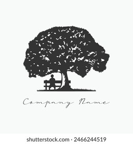 Silhouette of a man sitting on a bench under a tree