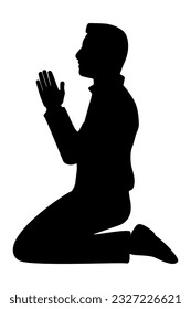 Silhouette of a man sitting on her knees praying. Side view