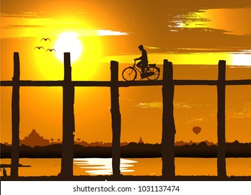 silhouette of a man taking bicycle on the old bridge,Mandalay,Myanmar,Burma