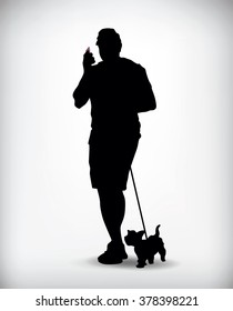 Silhouette of a man walking with a dog and talking on a cell