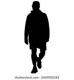 A silhouette of a man walking in shorts