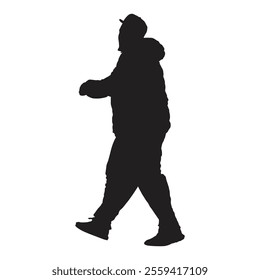 A silhouette of a man walking while wearing a cap