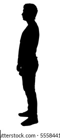 Silhouette of a man who stands sideways. A man looks into the distance.