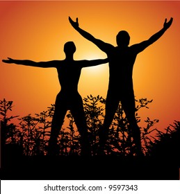 Silhouette Of A Man And Woman With Arms Lifted Up To The Sky