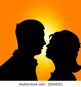 Silhouette of a man and a woman on sunset background.