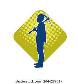 Silhouette of a man in worker costume carrying pick axe tool in action pose. Silhouette of a miner in action pose with pick axe tool.