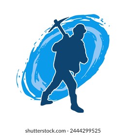 Silhouette of a man in worker costume carrying pick axe tool in action pose. Silhouette of a miner in action pose with pick axe tool.