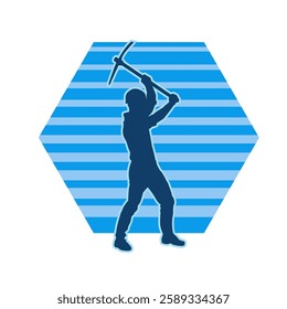 Silhouette of a man in worker costume carrying pick axe tool in action pose. Silhouette of a miner in action pose with pick axe tool.