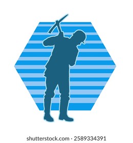 Silhouette of a man in worker costume carrying pick axe tool in action pose. Silhouette of a miner in action pose with pick axe tool.