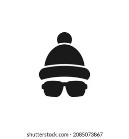 Silhouette of man's head with  hipster sun glasses and winter hat with pompon. Black skier holiday avatar with bobble hat.  Isolated on white. Vector flat illustration.