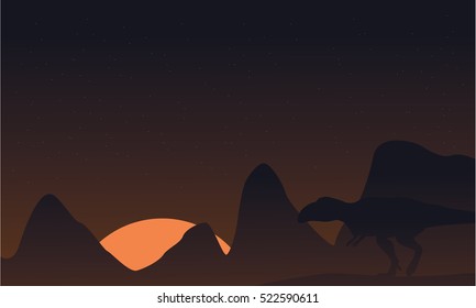 Silhouette of mapusaurus on brown sky landscape