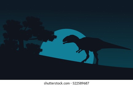 Silhouette of mapusaurus on hill at night