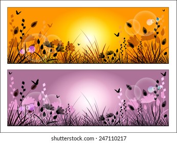 Silhouette of meadow grass and flowers on a background of the sunny sky.