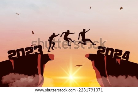 Silhouette of men jumping from a cliff over a cliff with sunlight. Sunset sky with clouds and flying birds. Leap concept in 2024.