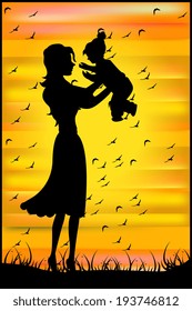 Silhouette of a mother and her baby on sunset background 