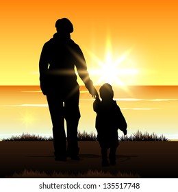 Silhouette of a mother with her child on evening background.