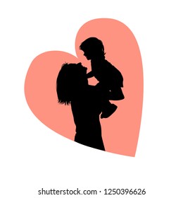 Silhouette of mother with her daughter in her arms