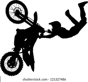 Silhouette of motorcycle rider performing trick