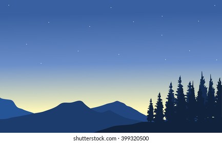 Silhouette of mountain from a far with spruce
