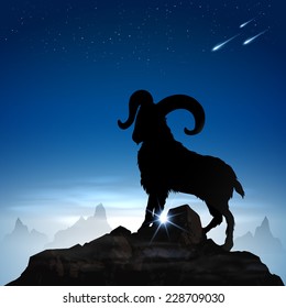 Silhouette mountain goat with blue sky background