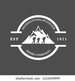 Silhouette of mountain with hikers walk across it in a circle with simple typography. Sign of nature lover, adventure, journey or travelers community logo or stamp