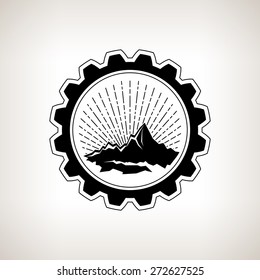 Silhouette  of the mountains and sunburst  in badge ,the vintage light rays and rocks and gear on a light background, black and white vector illustration