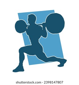 Silhouette of a muscular male in weight lifting pose at the gym. Silhouette of a muscular man in workout pose lifting barbell.