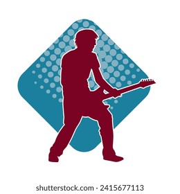 Silhouette of a musician playing electric guitar musical instrument. Silhouette of a male guitar player performing.