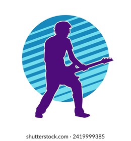 Silhouette of a musician playing electric guitar musical instrument. Silhouette of a male guitar player performing.