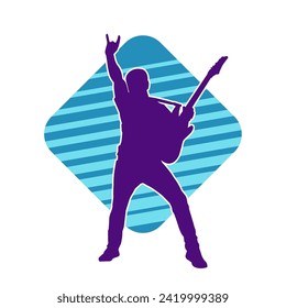 Silhouette of a musician playing electric guitar musical instrument. Silhouette of a male guitar player performing.