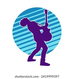 Silhouette of a musician playing electric guitar musical instrument. Silhouette of a male guitar player performing.