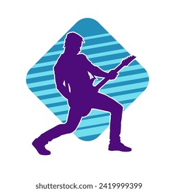 Silhouette of a musician playing electric guitar musical instrument. Silhouette of a male guitar player performing.