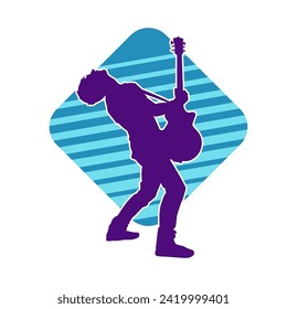 Silhouette of a musician playing electric guitar musical instrument. Silhouette of a male guitar player performing.