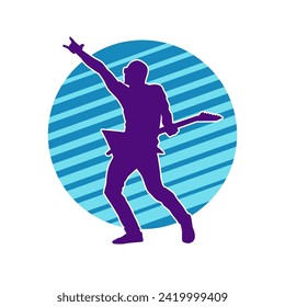 Silhouette of a musician playing electric guitar musical instrument. Silhouette of a male guitar player performing.