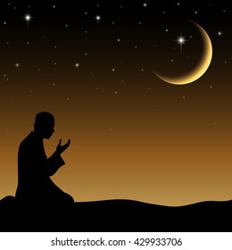 Silhouette of a Muslim praying in the when night