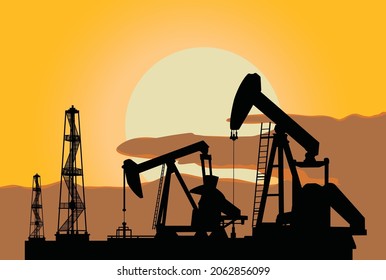 Silhouette oil pump jacks in sunset background 