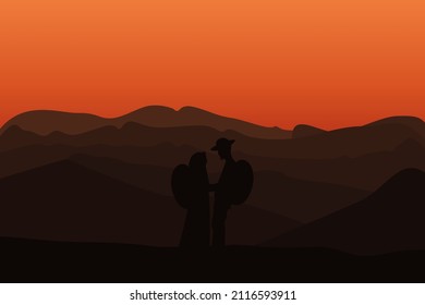 Silhouette of a pair of climbers standing from the top of a hill against the backdrop of mountains. romantic concept