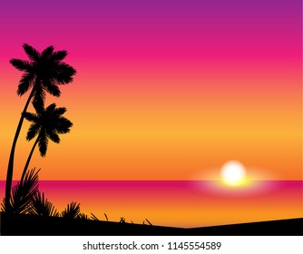 Silhouette of palm trees against the setting sun over the sea