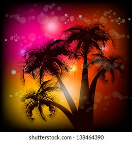 Silhouette of palm trees on a colorful background