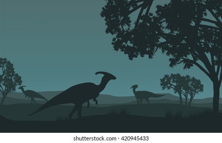 Silhouette of parasaurolophus walking in fields at night