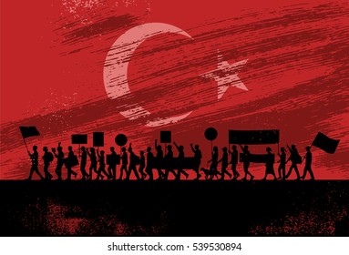 Silhouette of people protesting with flag of Turkey as a background