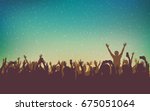 silhouette of people raise hand up in concert with smartphone and digital dot pattern on vintage color background