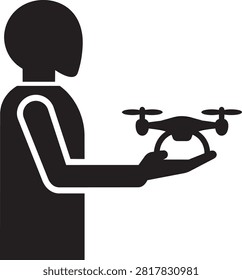 Silhouette of a person holding a small drone in their hand