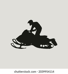 silhouette of person riding a snow motorbike