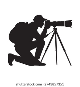 Silhouette of a photographer kneeling and operating a camera on a tripod