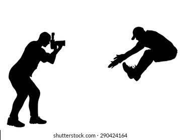 Silhouette photographer at work with action athlete.