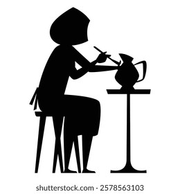 Silhouette of a Potter Shaping Clay at a Spinning Wheel