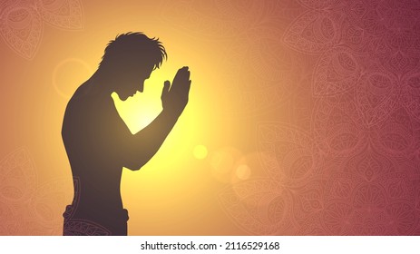 Silhouette of a praying man on the background of the sunset sun