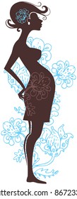 Silhouette of pregnant woman in flowers